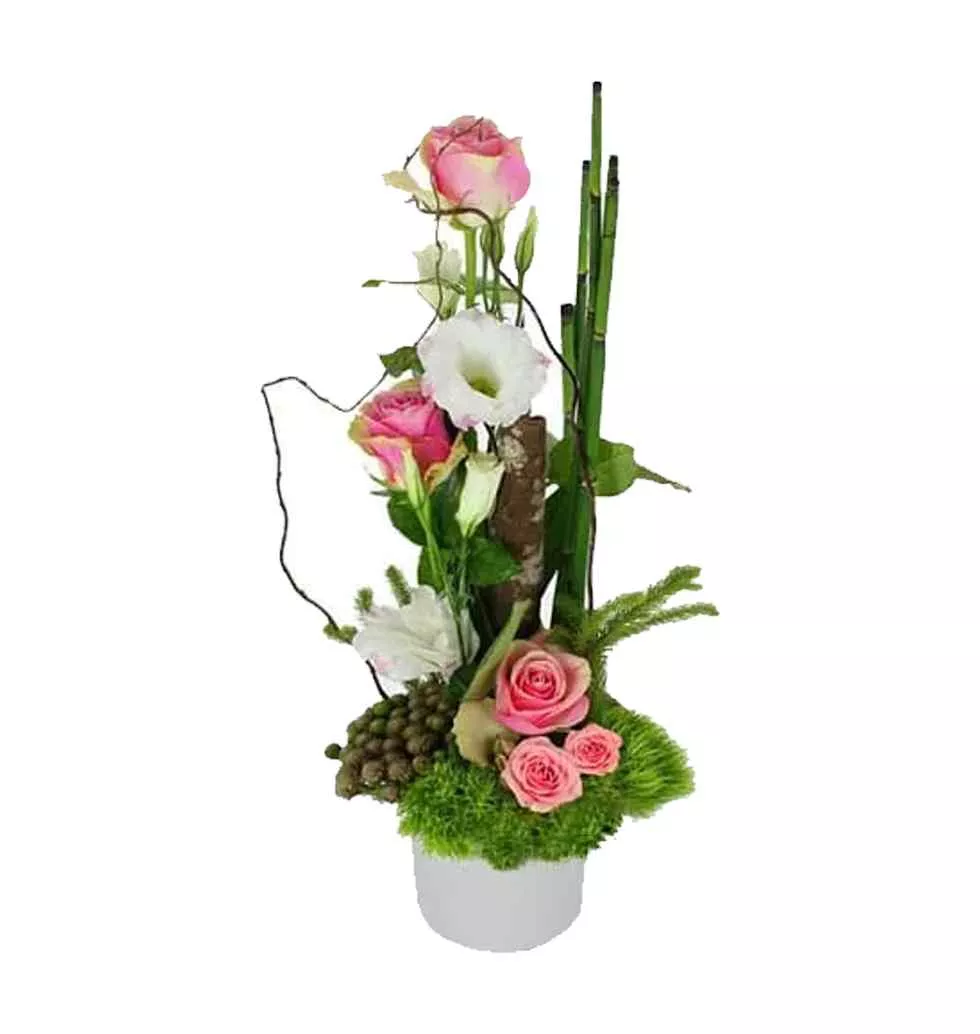 Expressive Combination of Pink roses, white lisianthus in a glass container